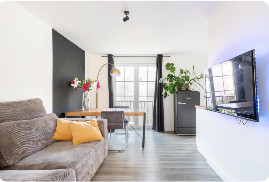 a living room with a couch and a television at Studio Romantic in Zandvoort