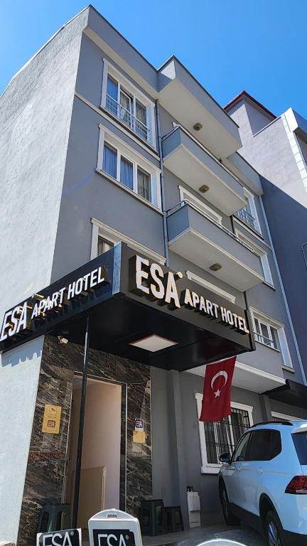 a white car parked in front of a hotel at Esa Apart Hotel in Trabzon