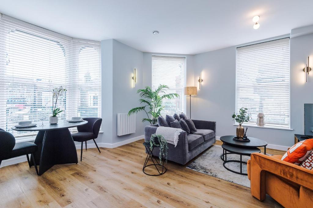 a living room with a couch and a table at Harrogate House Apt 1 - Cheltenham Parade View in Harrogate