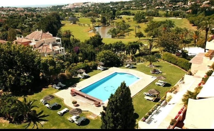 an aerial view of a house with a swimming pool at Stunning suite at Hotel Del Golf, 5 stars and frontline Golf, Porto Banus, Marbella in Marbella