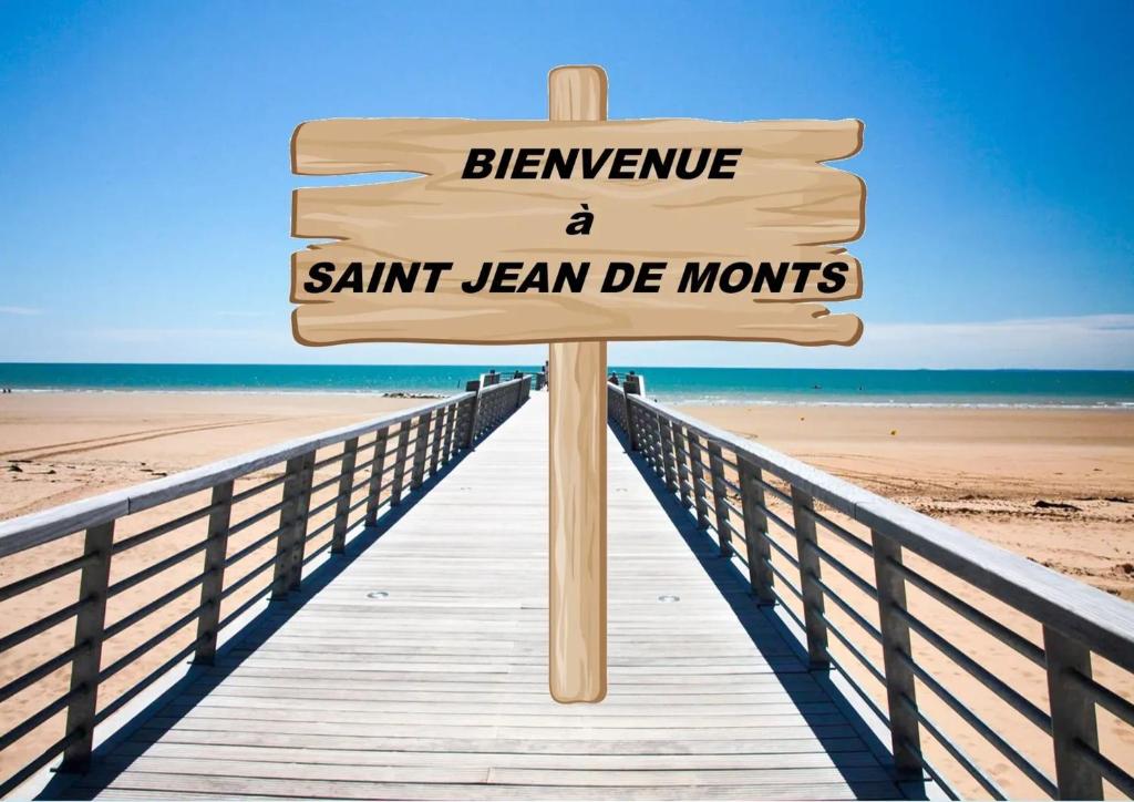 ein Holzschild auf einer Strandpromenade in der Unterkunft Bungalow convivial à Saint-Jean-de-Monts avec piscine partagée in Saint-Jean-de-Monts