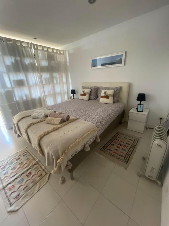 Postel nebo postele na pokoji v ubytování São João Beach Lounge