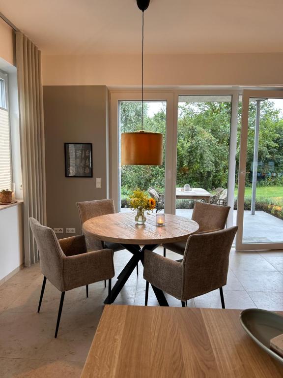 una sala da pranzo con tavolo e sedie in legno di Ferienwohnung Clemens, neue Wohnung zentral und hochwertig ad Ahaus