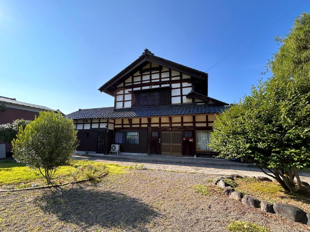 a large house with a gambrel roof at Traditional Japanese Style Vacation Rentals ToBay 古民家民泊藤兵衛 in Eiheiji