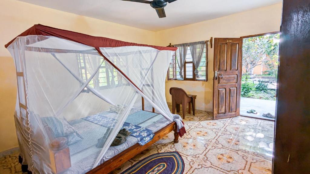 Postel nebo postele na pokoji v ubytování Mwana House