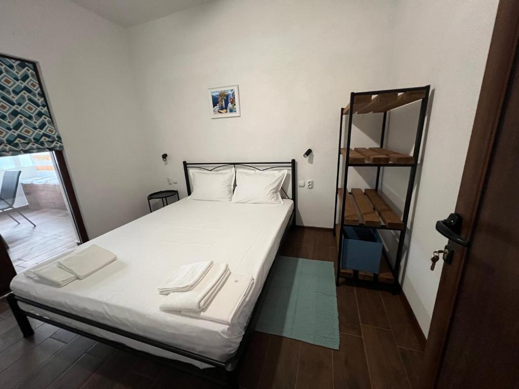 a small bedroom with a bed and a mirror at Guest House Kalina,Studio 3 in Ammouliani