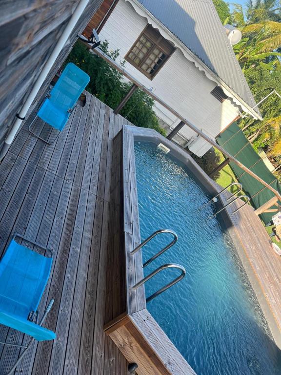 an overhead view of a swimming pool on a wooden deck at Les Alpinias in Sainte-Anne
