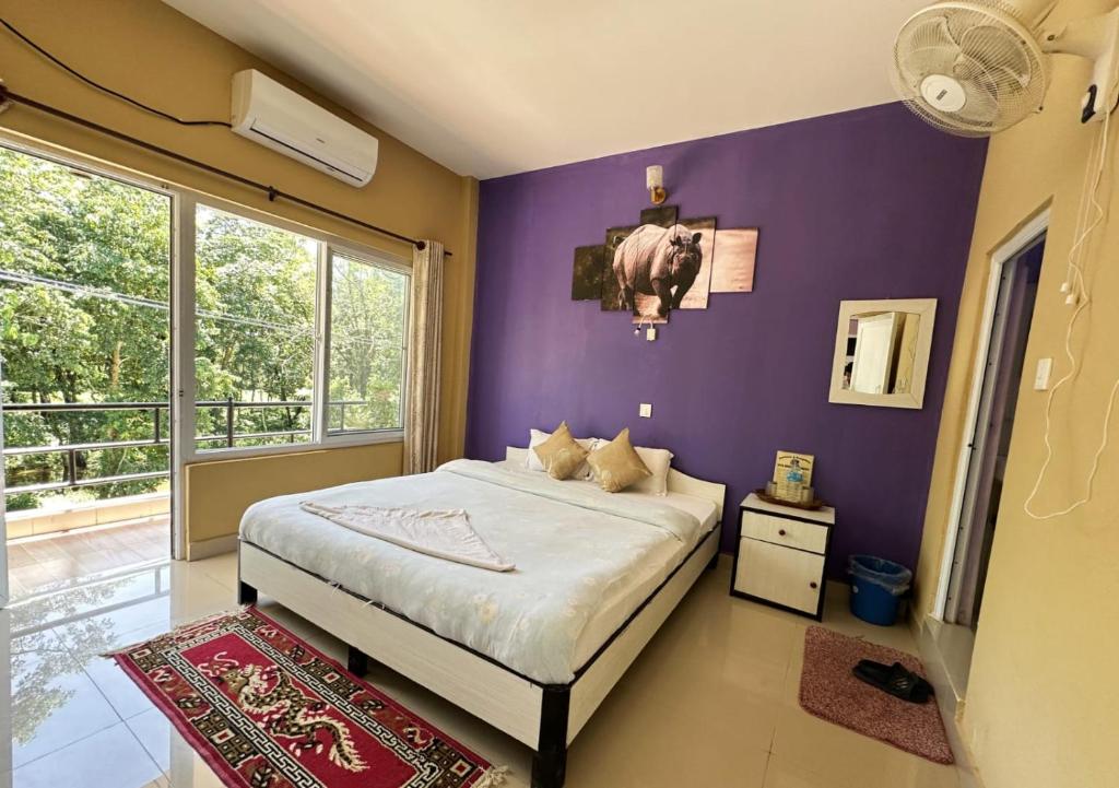 Postel nebo postele na pokoji v ubytování Hotel Rhinoceros-Homestay