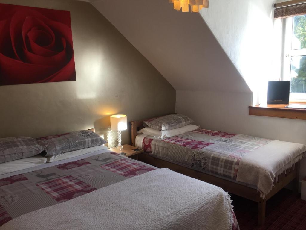 Postel nebo postele na pokoji v ubytování Cameron Guest House
