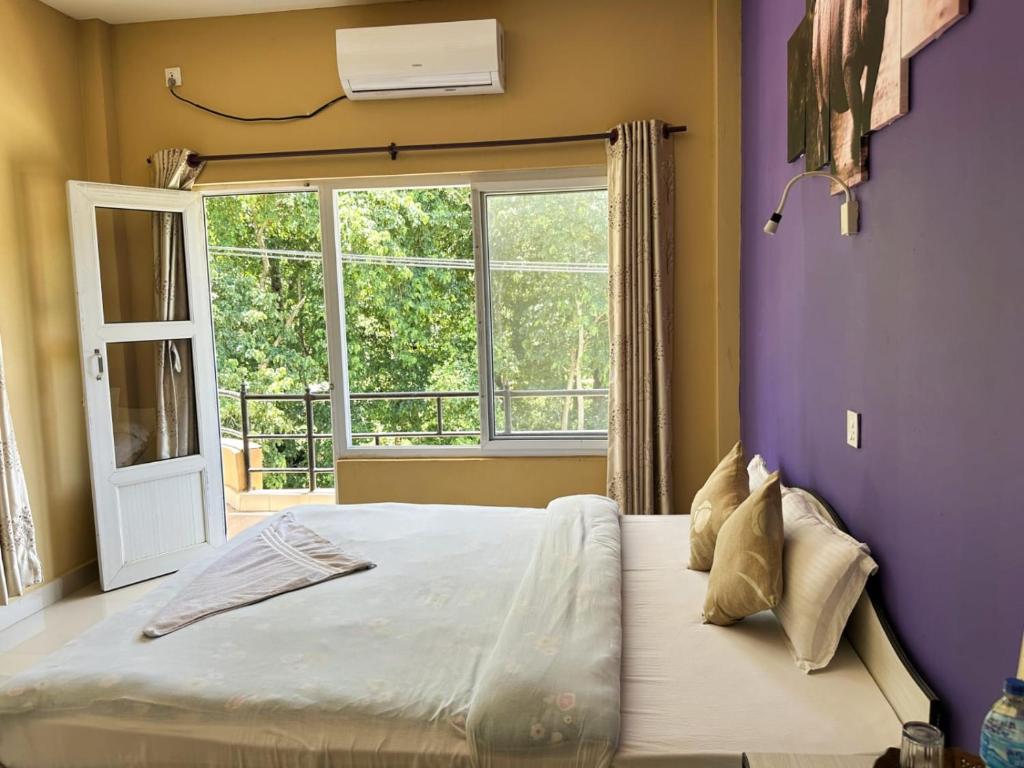 Postel nebo postele na pokoji v ubytování Hotel Rhinoceros-Homestay