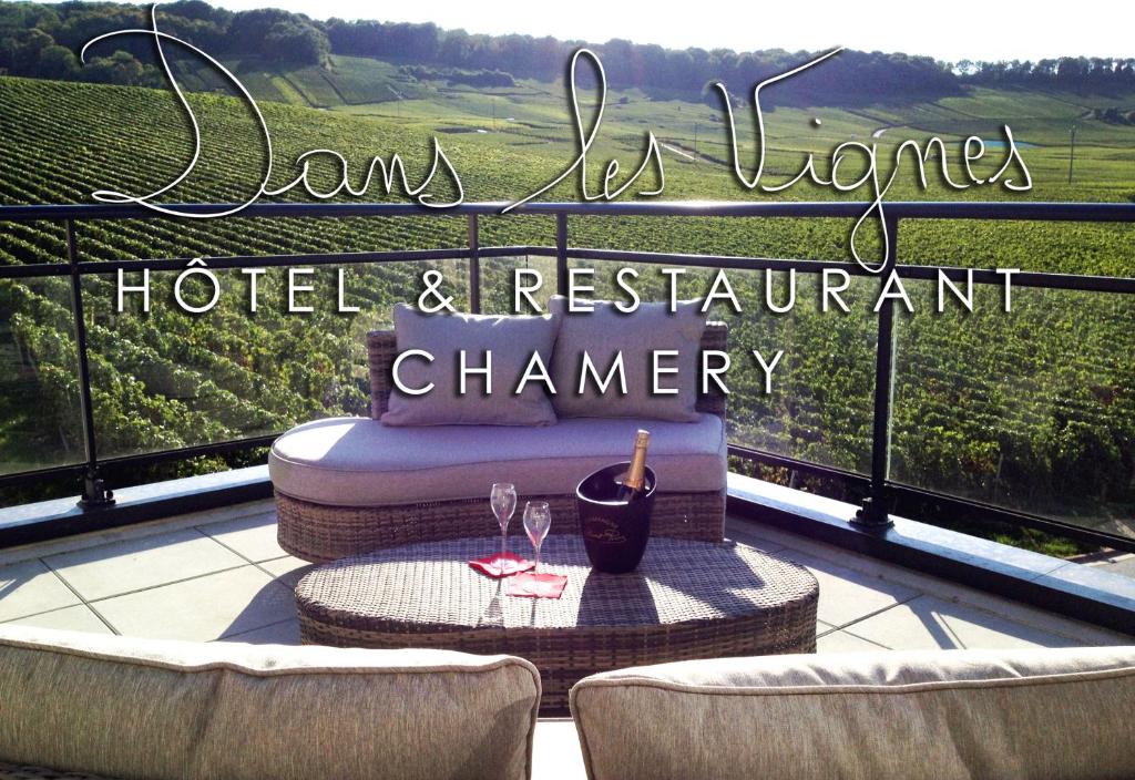 a balcony with a table and two glasses of wine at Dans les Vignes in Chamery