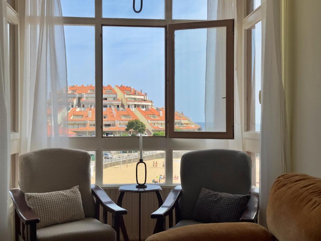 a room with two chairs and a large window at Miramar - 5710 in Quejo