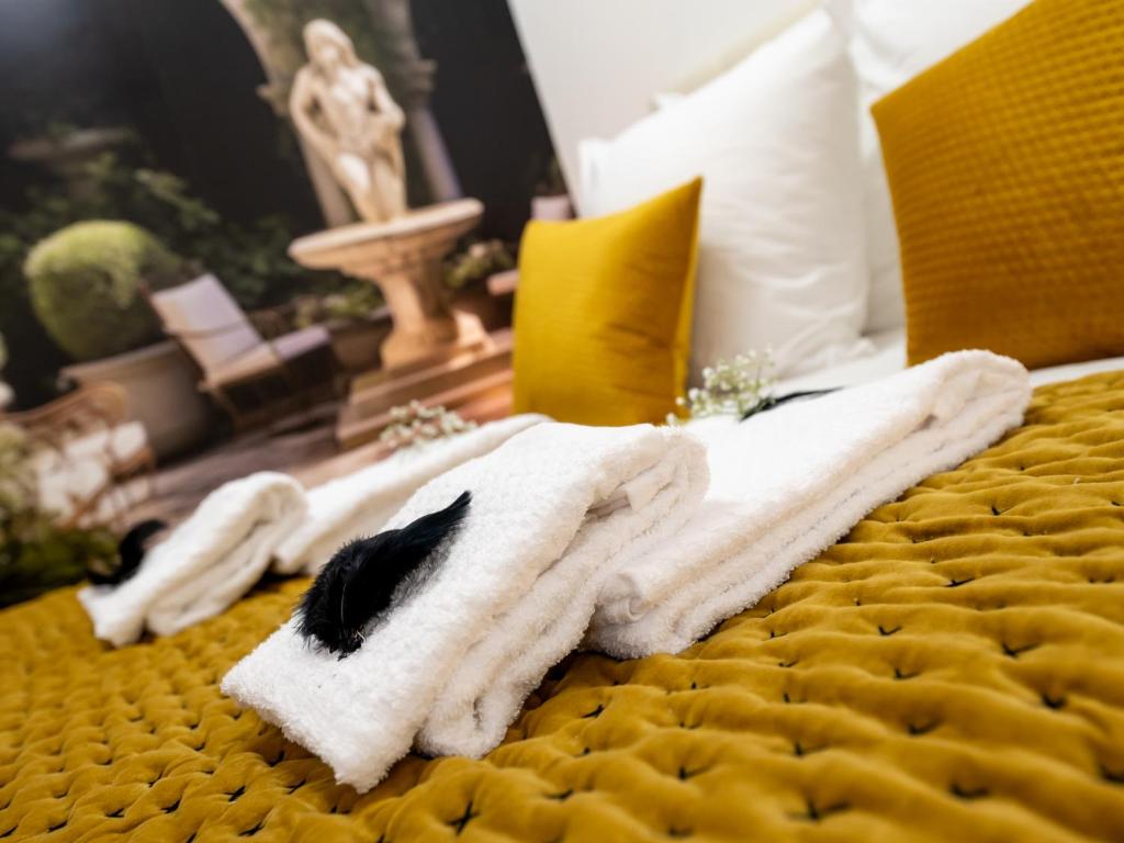 a white towel is laying on a bed at La Petite Vienna - Vienna authentica in Vienne