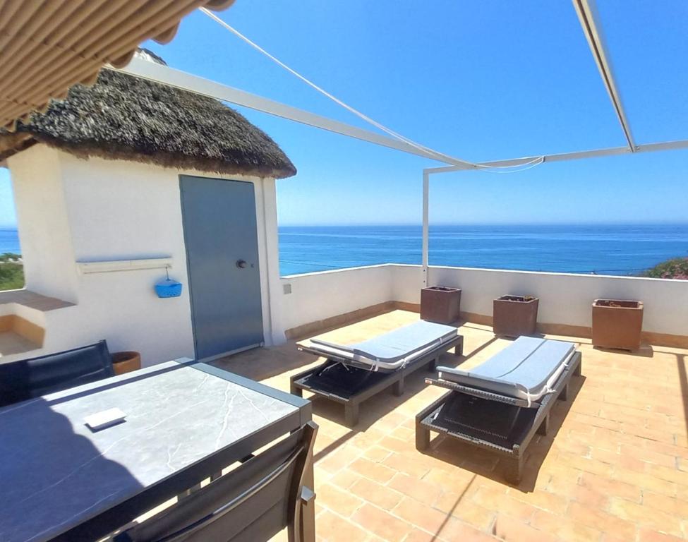 a balcony with a view of the ocean at Mandala Bungalows - Adults Only in Los Caños de Meca