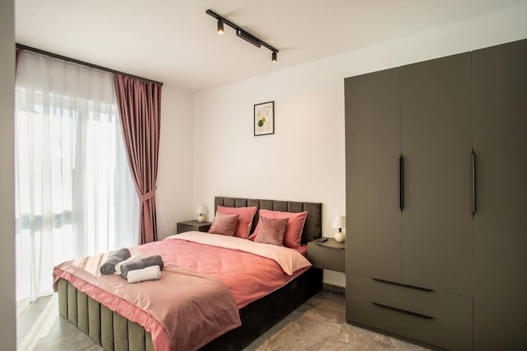 a bedroom with a large bed and a window at Bia Skyline Retreat in Oradea