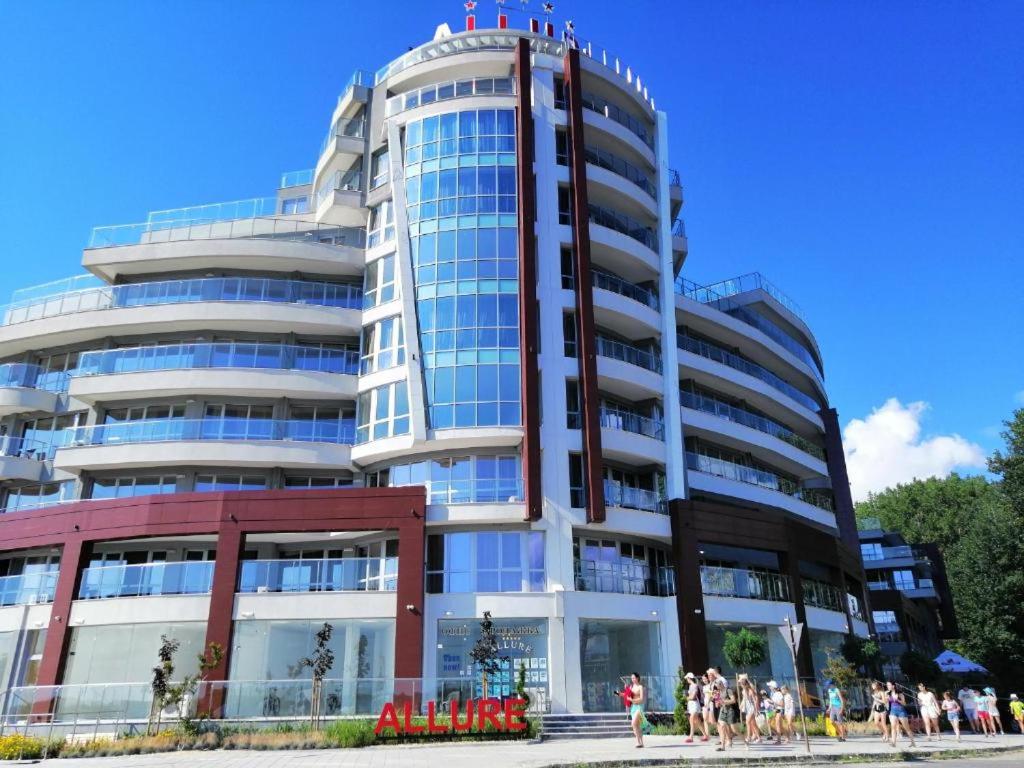 a large building with people standing outside of it at Allure - Lighthouse apartment B35 in Primorsko