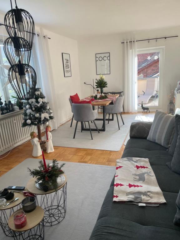 a living room with a couch and a table at Ferienhaus La Perle im Hils in Delligsen