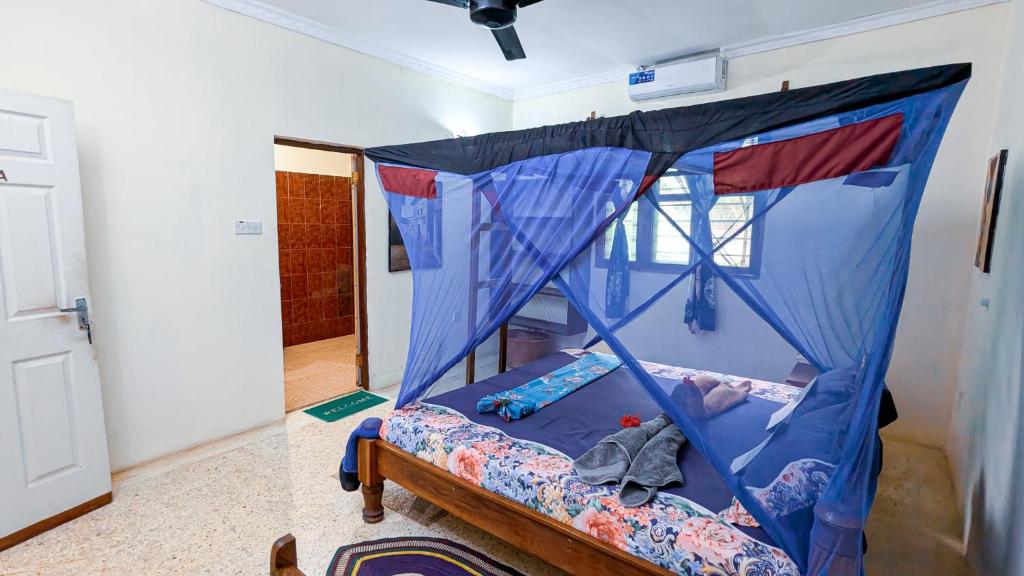 Postel nebo postele na pokoji v ubytování Mwana House