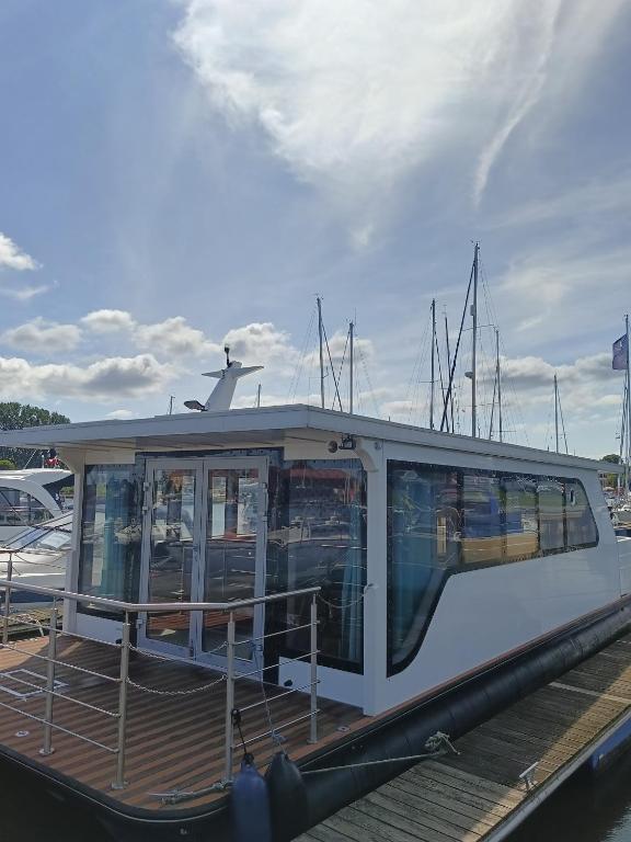 a boat is docked at a dock at MOONLIGHT HOUSEBOAT in Świnoujście