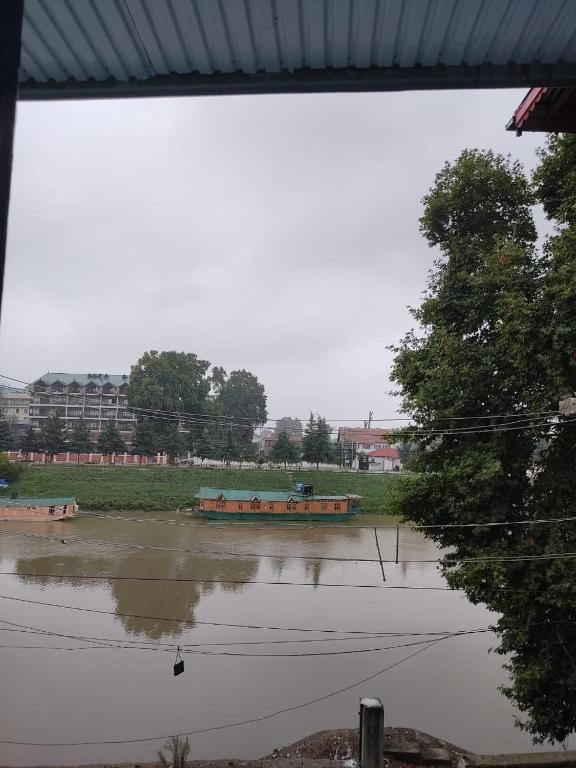 a flooded field with a boat in the water at The Qulsum Homestay in Srinagar