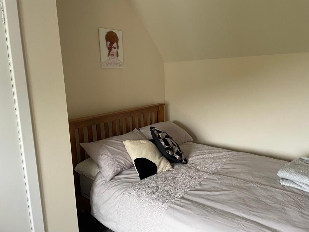 a bedroom with a bed with two pillows on it at Oldshorecroft in Sheigra