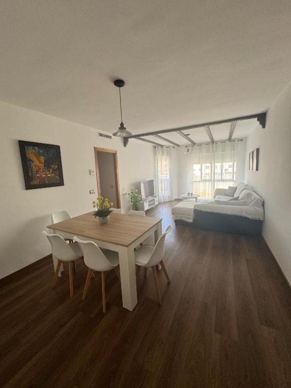 a living room with a table and a bed at Casa Emma in Burriana