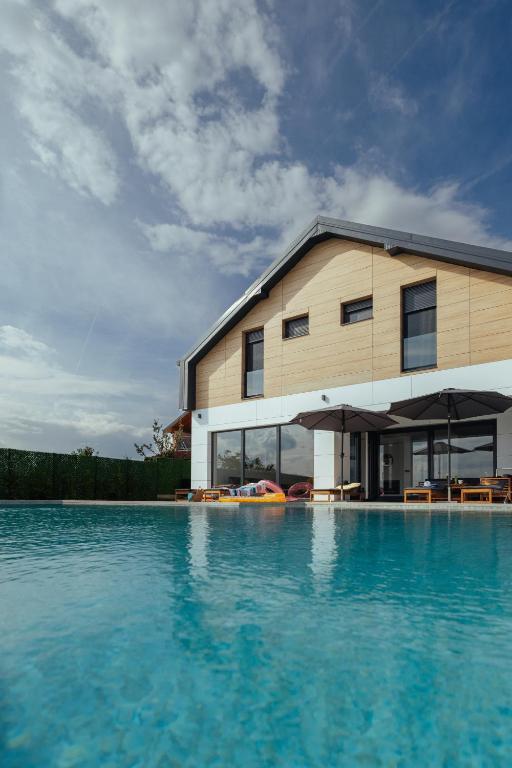 a house with a swimming pool next to a building at Vila Pogled in Vrdnik