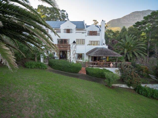 a large house with a large garden and trees at De Molen Guest House in Somerset West