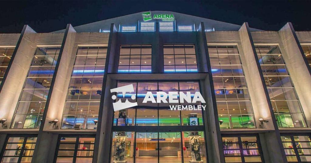 a building with a sign on the front of it at Premium London Apartment - 10 minutes from Wembley Stadium, OVO Wembley Arena in London