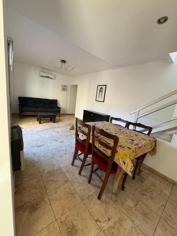 a living room with a table and chairs and a couch at Moderno departamento caseros in Caseros