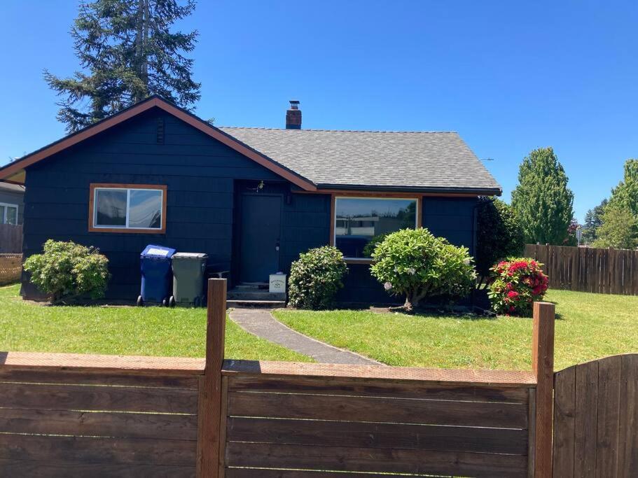 a blue house with a fence in front of it at 1940s Urban charmer modern upgrades in Auburn