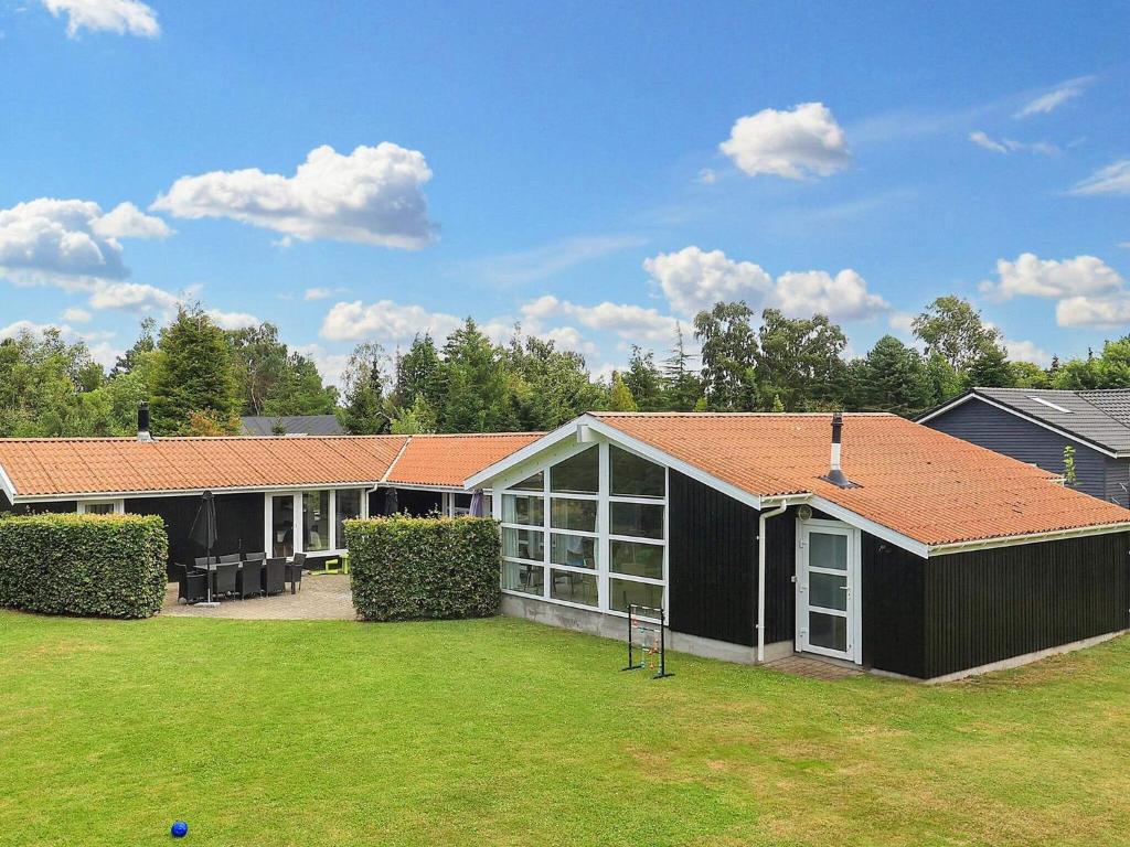 a large house with a large yard in front of it at 14 person holiday home in Væggerløse-By Traum in Marielyst
