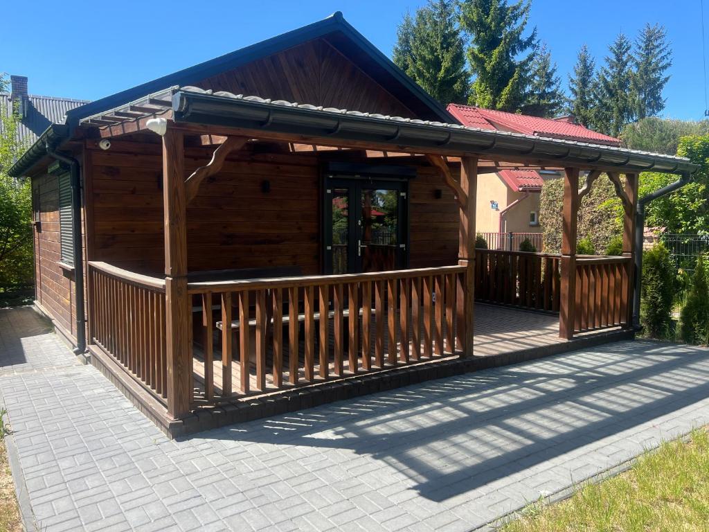 a wooden gazebo with a wooden deck at Domek Leon in Okuninka