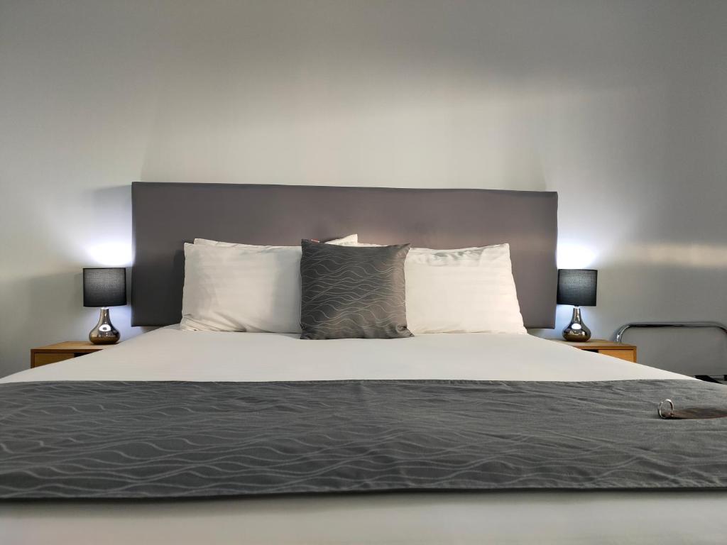 a bedroom with a large bed with two lamps at Tongariro Boutique B&B in National Park