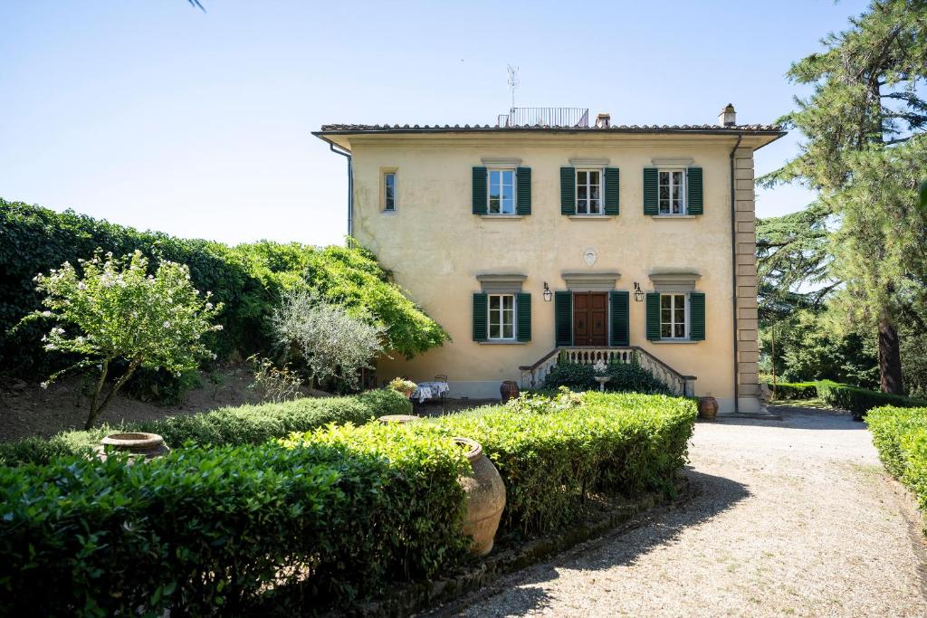 a large house with bushes in front of it at Villa Poggio Bello in Florence