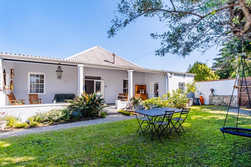 a house with a yard with a swing at Blue Bell in Hermanus