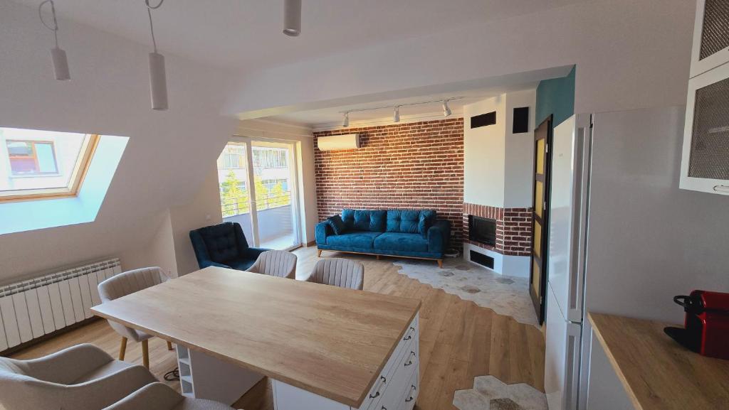 a living room with a table and a blue couch at Urban Retreat - Sliven City Center in Sliven