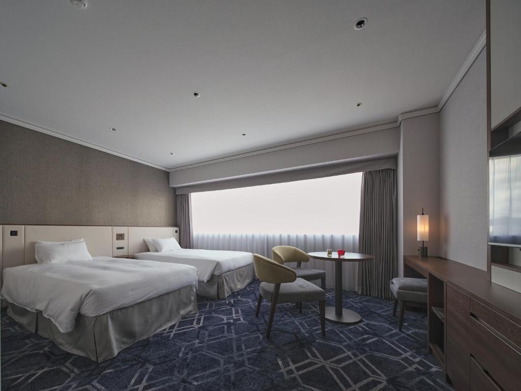 Postel nebo postele na pokoji v ubytování Hotel Nikko Himeji