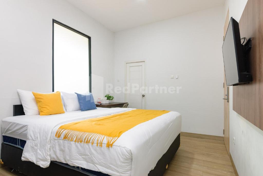 En eller flere senge i et værelse på Go Home Residence RedPartner