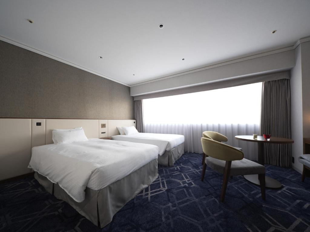 Postel nebo postele na pokoji v ubytování Hotel Nikko Himeji
