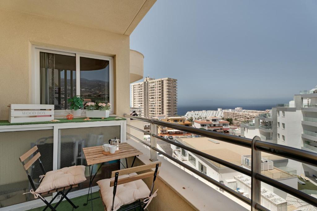 a balcony with two chairs and a table on it at Apto Sol Paraiso Sunset View in Adeje