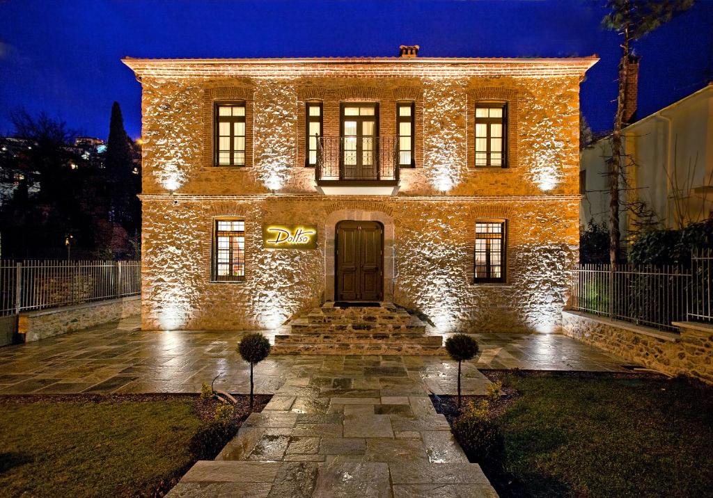 a large brick building with lights on it at night at Hotel Doltso in Kastoria