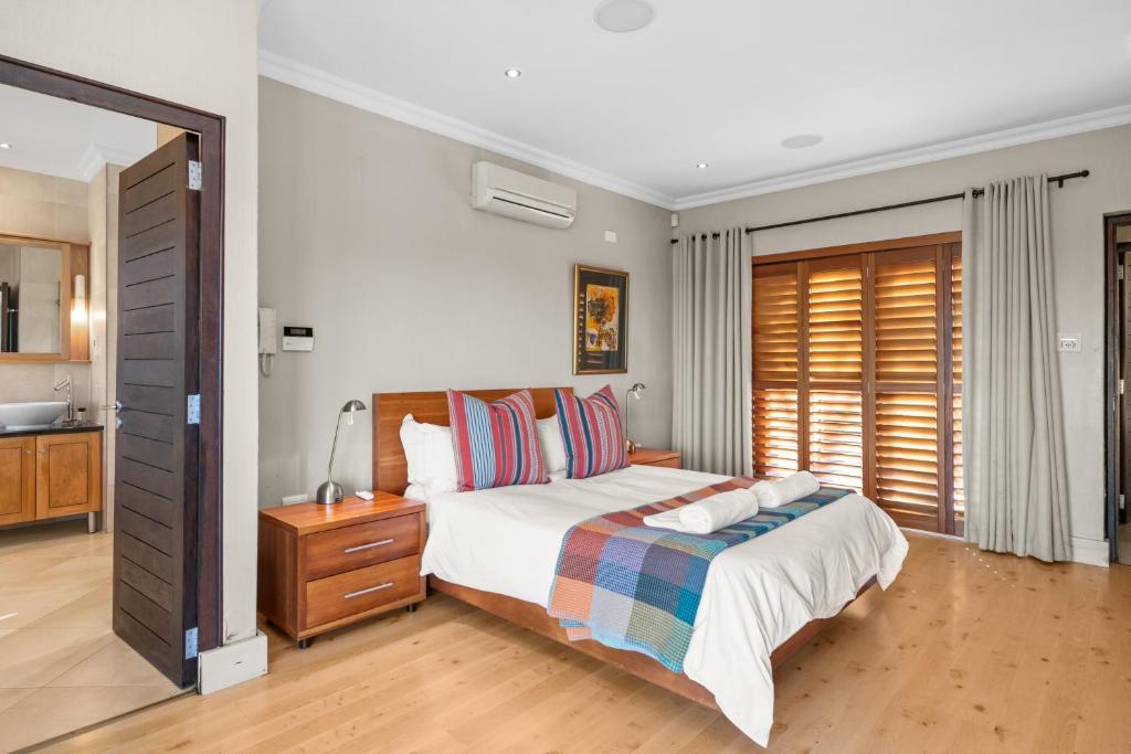 a bedroom with a bed and a dresser and a mirror at San Lameer Villa 14205 - 4 Bedroom Luxury - 8 pax -San Lameer Rental Agency in Southbroom