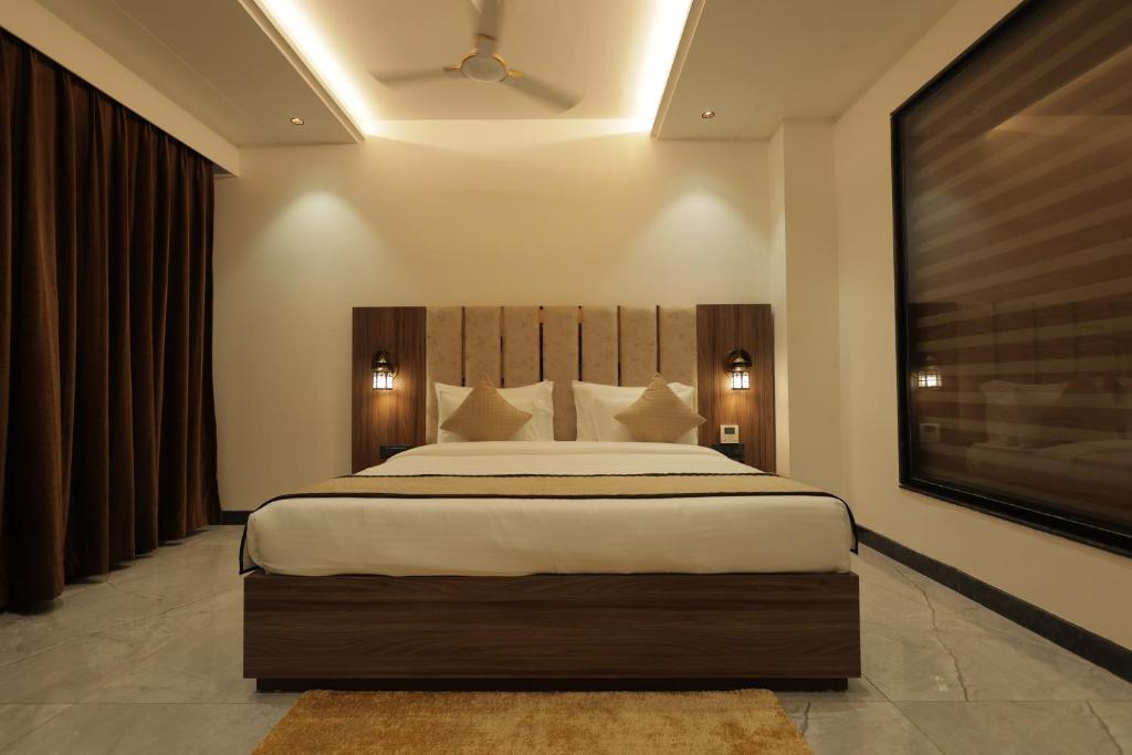 En eller flere senge i et værelse på SNJ Taj Grand