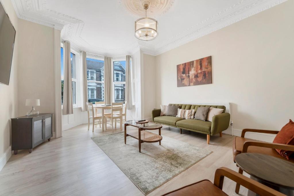 a living room with a couch and a table at Modern Two Bedroom Central Flat in Weston-super-Mare