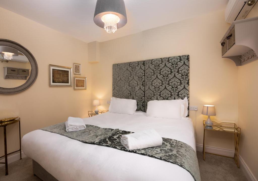 a bedroom with a large bed with two towels on it at Caboose in Salisbury