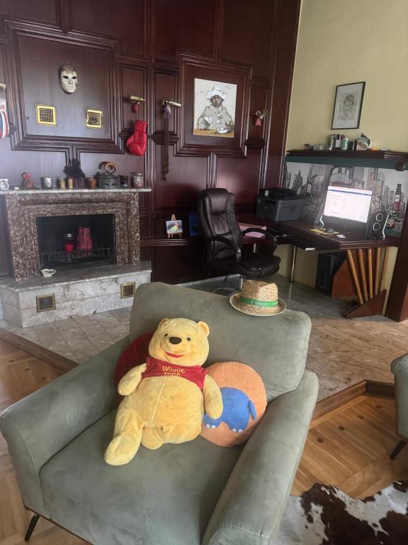 a teddy bear sitting on a couch in a living room at Apartma Mladinska in Maribor