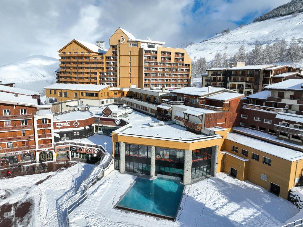 a city in the snow with buildings at Belambra Clubs Les 2 Alpes Les Crêtes in Les Deux Alpes