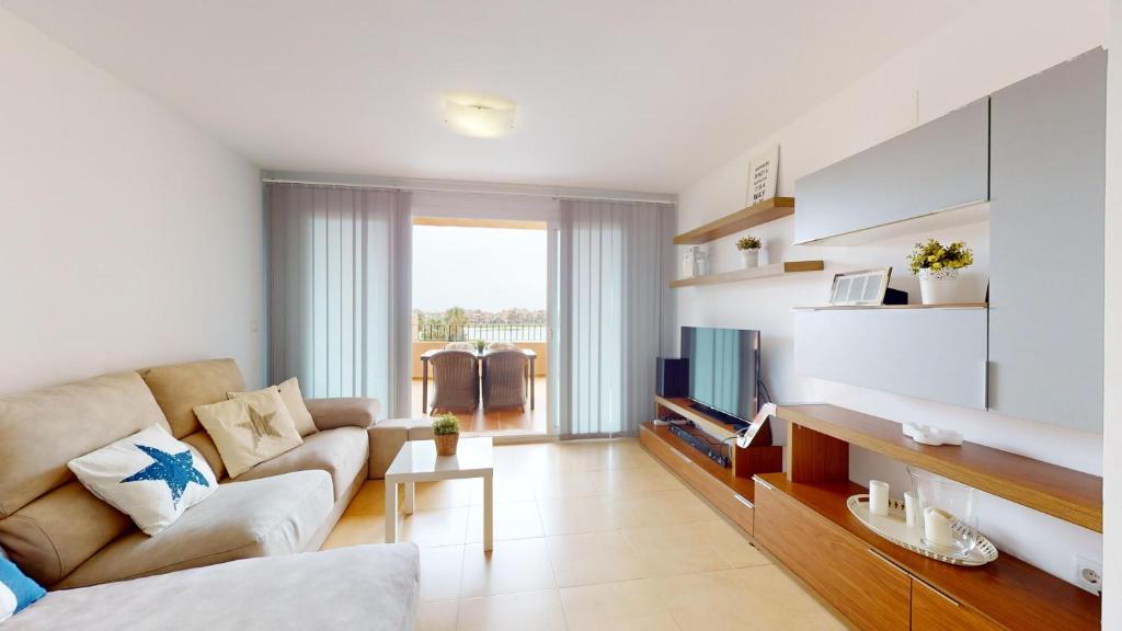 a living room with a couch and a tv at Mar Menor Golf Resort in Murcia