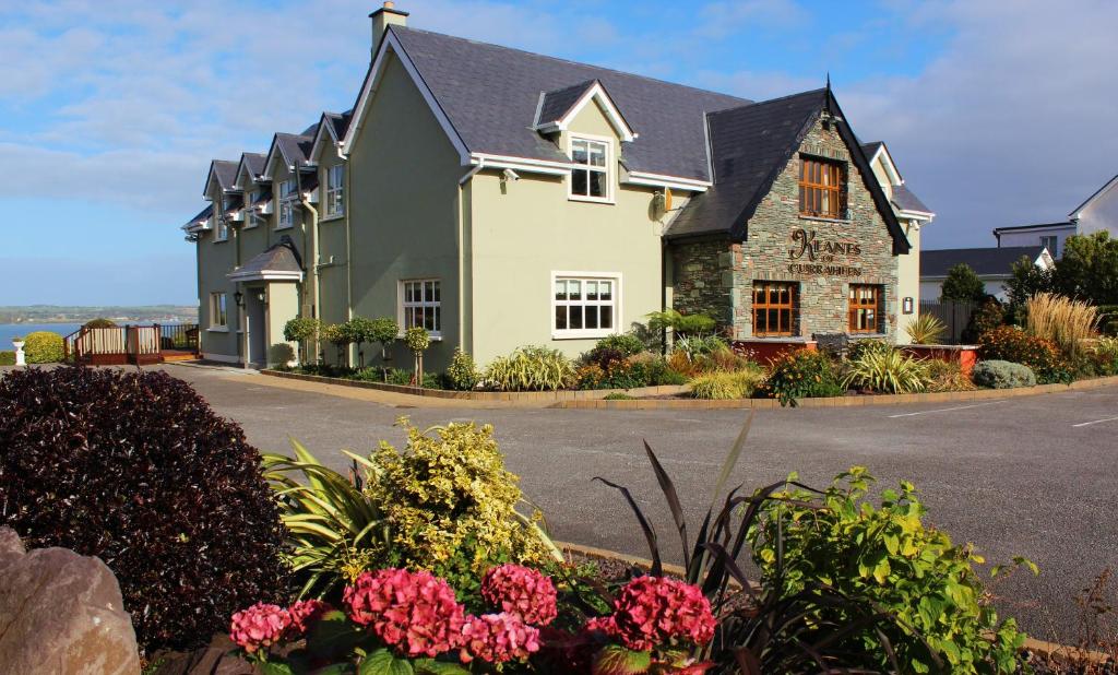 a house with flowers in front of a street at Keanes of Curraheen in Tralee